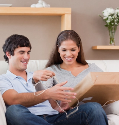 Two people are opening a package.
